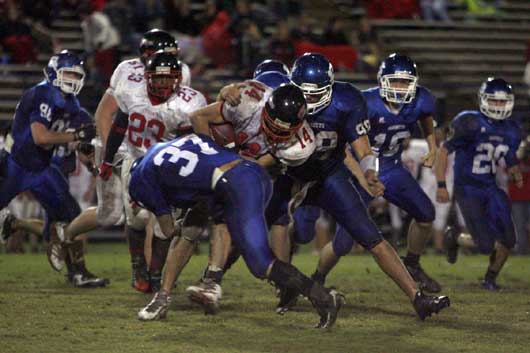 Bryant linebacker Trey Sowell (37) and defensive tackle Josh Hampton (98) combine to tackle Russellville quarterback Lane Reves during Friday's game. (Photo by Rick Nation)