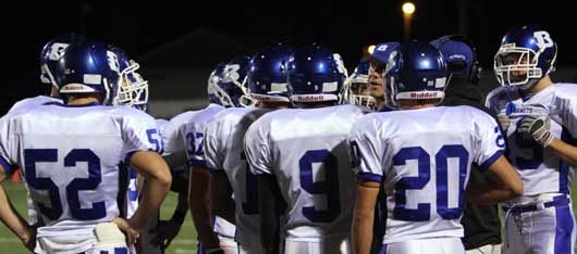 Bryant defensive coordinator Steve Griffith gathers his squad around him for instructions. (Photo by Rick Nation)