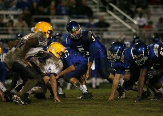 Bryant quarterback Hayden Lessenberry (5) prepares to take a snap from Blain Jackson. (Photo by Rick Nation)