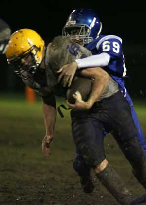 Chris Stringer makes a tackle from behind Catholic's Cole Boardman. (Photo by Rick Nation)