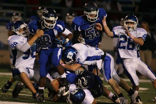 Bryant's Josh Hampton (98) and Brady Butler (36) hit Conway's Jemarkus Harmon. (Photo by Rick Nation)