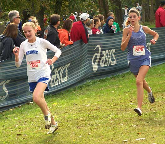 Bryant freshman Hannah Raney, left, out-kicks a rival during her school-record run at the prestigious Chile Pepper Invitational in Fayetteville Saturday.