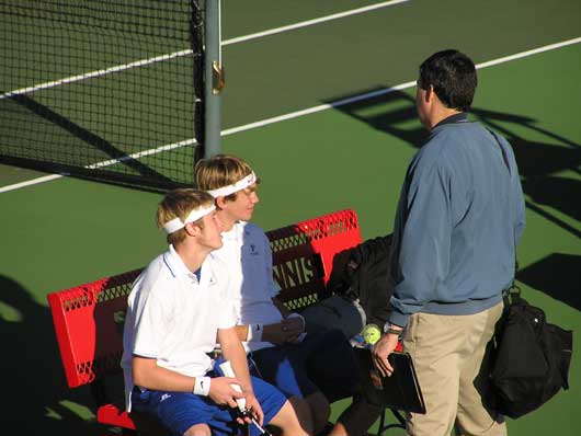 Bryant tennis coach Steve Wilson talks with doubles team Kyle Nossaman and Jonathan Lowery between sets at the Class 7A State tournament. (Photo courtesy of Rob Nossaman)