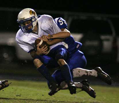 Bryant's Hunter Schelle (back) and a Sheridan ball carrier leave the ground as they make contact. (Photo by Rick Nation)
