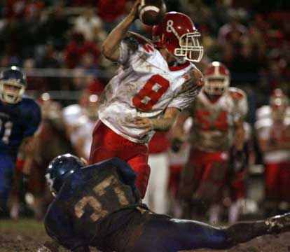 Bryant linebacker Trey Sowell (37) tries to bring down Cabot quarterback Seth Bloomberg. (Photo by Rick Nation)