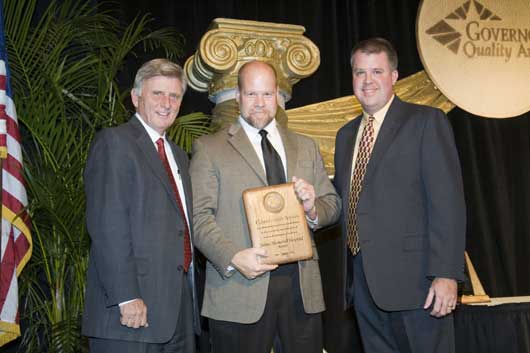 Saline Memorial Hospital (SMH) was recently recognized for the 3rd year in a row for performance excellence at the 15th Annual Awards Celebration for the Governor’s Quality Award Program at the DoubleTree Hotel in Little Rock. Presenting and accepting the award for SMH from left to right: Governor Mike Beebe, Steve Henson, SMH Vice President and Chief Operating Officer and Glenn Woods, Plant Manager for Lockheed Martin Missiles and Fire Control and 2006 winner of the Governor’s Award for Performance Excellence.