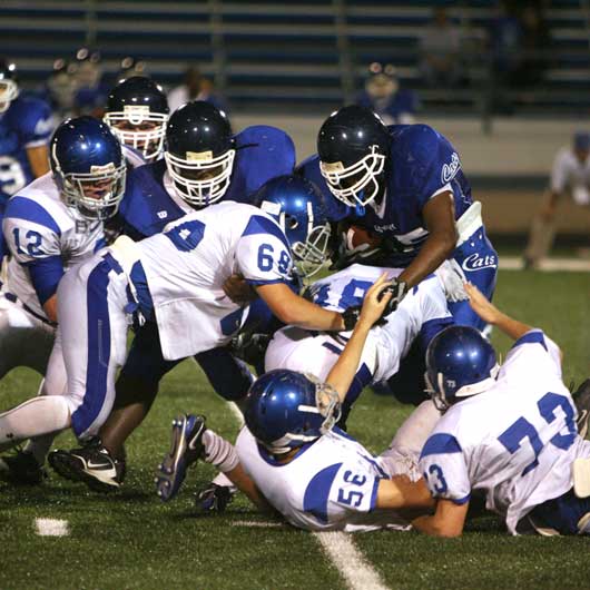Bryant defenders Ian Shuttleworth (12), Chris Stringer (69), Daniel Richards (18), Hayden Stewart (56) and Austin Wadley (73) pile up Conway running back Quincy Wardlow. (Photo by Rick Nation)