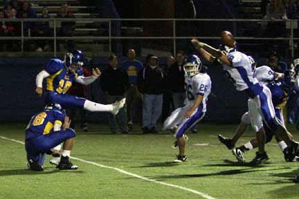 Bryant's Hunter Mayall (18) stretches out to block Logan Bussard's field goal attempt. (Photo by Rick Nation)