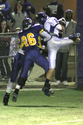 Bryant's Brandon Parish (2) hauls in a pass under duress from North Little Rock's J.J. Shearins. (Photo by Rick Nation)