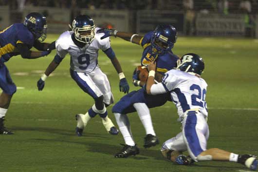 Bryant's Tanner Tolbert (20) was flagged for a "horse-collar" tackle on this play against North Little Rock's diminutive running back Tim Johnson (7) as Sammill Watson (9) hustles in to help. (Photo by Rick Nation)