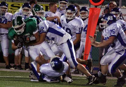 Ben Seale and Brady Butler stop Van Buren's Jacob Jenkins. (Photo by Rick Nation)