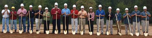 Engineers, construction workers and city officials and employees gather to break ground at the location for the aquatic center at Bishop Park on Boone Road.  Left to right:  Clay Bishop, Shawkat Ali, Jimmy Pruitt, Boyce Smith, Derek Phillips, Rae Ann Fields, Rick Meyer, Larry Mitchell, Robby Young, Danny Steele, Sandy Miller, Jeremy Lemons, Doug Harvey, Joyce Boswell, Robert Summerville, Luke Neel, and Ken Palmquist. (Photo by Lana Clifton)