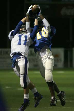 Bryant's Hayden Daniel (11) and North Little Rock's Gary Vines (10) go up for a pass that neither was able to catch during Thursday's game. (Photo by Rick Nation)