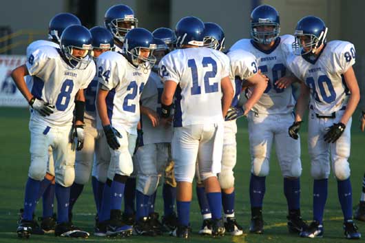 The Bryant White Hornets huddle up on offense. (Photo by Rick Nation)