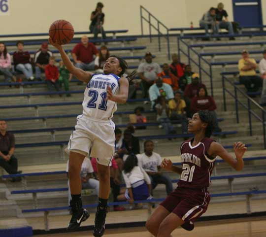Bryant freshman Kiara Harris drives to the basket about Morrilton's Lisa Brockman. (Photo by Rick Nation)