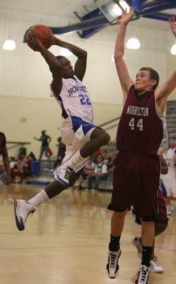 Bryant's Marcus Wilson (22) takes a running jumper over Morrilton's Kirk Clifton. (Photo by Rick Nation)