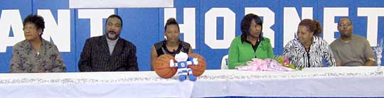 Alana Morris, center, is joined by her family on Thursday as she signed a letter of intent to attend Tennessee State University on a basketball scholarship.