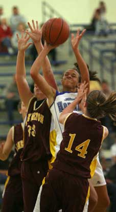 Bryant's McKenzie Adams splits a pair of Lake Hamilton defenders on the way to the basket during Monday night's game. (Photo by Rick Nation)