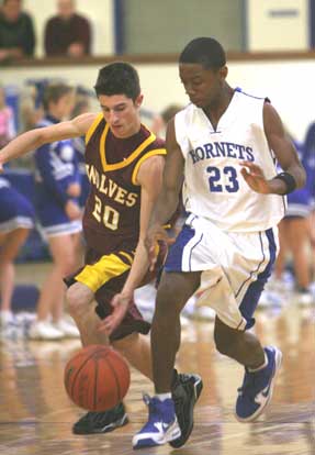 Bryant's Strodney Davis (23) battles for a loose ball. (Photo by Rick Nation)
