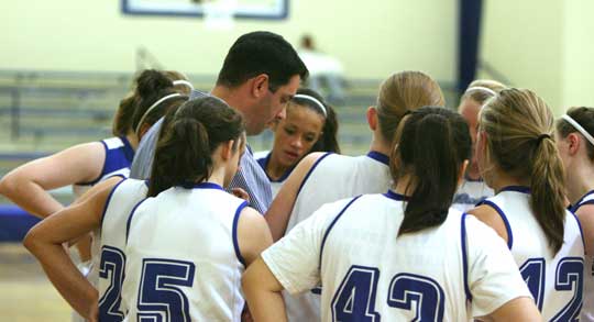 The Bryant Lady Hornets freshman team huddles around head coach Eric Andrews during a timeout. (Photo by Rick Nation)