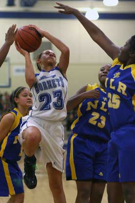 McKenzie Adams of Bryant goes up for a shot surrounded by North Little Rock's Melissa Bridwell, left, Darian Banks (23) and Tashika Harris (25). (Photo by Rick Nation)