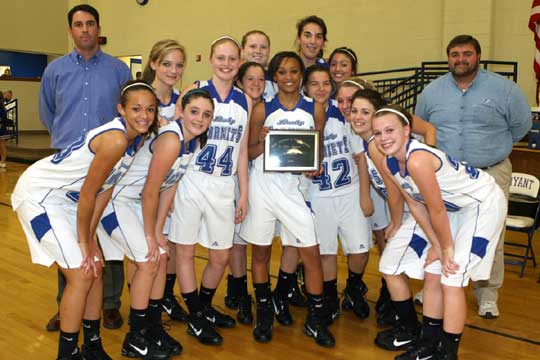 The Bryant Lady Hornets freshman team with head coach Eric Andrews, left, and athletic director Tom Farmer, right.