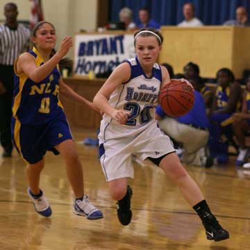 Bryant's Logan Davis (20) drives around North Little Rock's Melissa Bridwell. (Photo by Rick Nation)