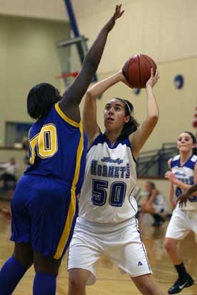 Bryant's Whitney Myer tries to get a shot off over North Little Rock's Keandra Tillman, left. (Photo by Rick Nation)