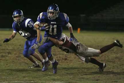 Hayden Daniel (11) cuts inside a block by Devon Sears (26). (Photo by Rick Nation)