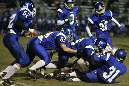 The Hornets freshman defense converges on a Benton running back, including Hunter Berry (31), Austin Powell (6), Tyler Hayden (68), Stoney Stevens (32), Arron Bell (8) and Tim Kelly (52). (Photo by Rick Nation)