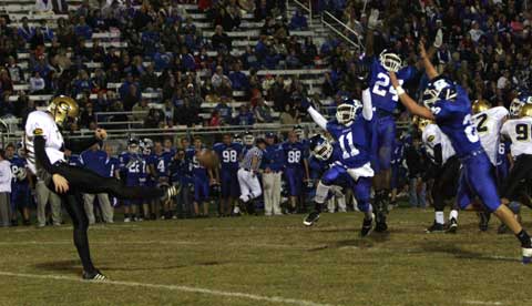 Dillon Winfrey (11), James Glasper (24) and Tanner Tolbert (20) make a bid to block John Riggins' punt during Thursday's Central-Bryant game. (Photo by Rick Nation)