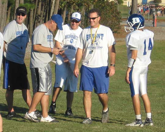 From left, offensive coaches Jason Hay, Dale Jones, volunteer Brandon Butler, head coach Paul Calley and senior quarterback Jimi Easterling share a laugh during a recent practice.