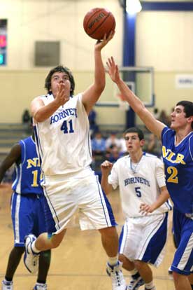Zach Cambron (41), shown here in a game earlier this season, goes up for a shot in front of teammate Riley Hall (5). (Photo by Rick Nation)