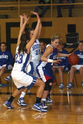 Bryant's Brooke Parish (20) and Kenzee Calley (23) trap Arkadelphia's Briana Seale. (Photo by Rick Nation)