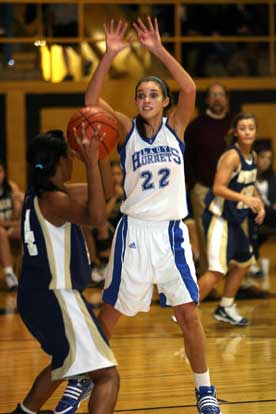 Hannah Goshien (22) defends against Pulaski Academy's Calen Blann. (Photo by Rick Nation)