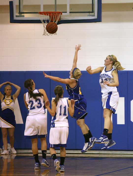 Bryant's Abbi Stearns swats away a shot by Sheridan's Mycah Love as teammates Kenzee Calley (23) and Haley Montgomery (11) look on. (Photo by Rick Nation)