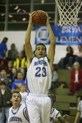 K.J. Hampton pulls down one of his seven rebounds during Tuesday's game. (Photo by Rick Nation)