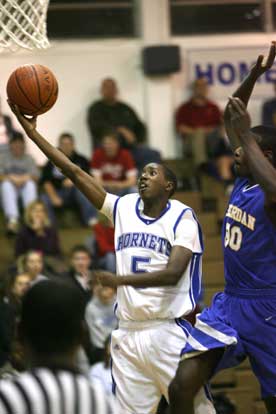 K-Ron Lairy goes up for a lay-in after getting past Sheridan's R.J. Comic. (Photo by Rick Nation)