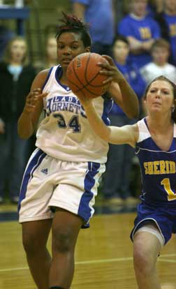 Alana Morris tries to retain possession as Sheridan's Amy Strange (1) reaches in. (Photo by Rick Nation)