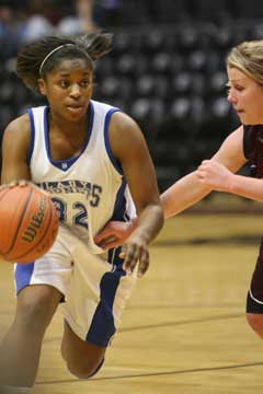 Bryant's Shanika Johnson (32) drives around a Benton defender. (Photo by Rick Nation)