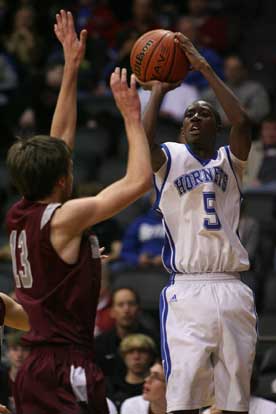 Senior K-Ron Lairy who led the Hornets with 14 points shoots over Benton's Nick Garner (13). (Photo by Rick Nation)