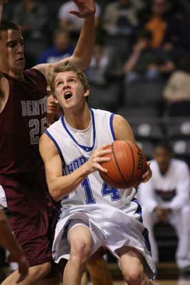 Bryant's L.J. McLaughlin (30) drives past Benton's Nick Garner. (Photo by Rick Nation)