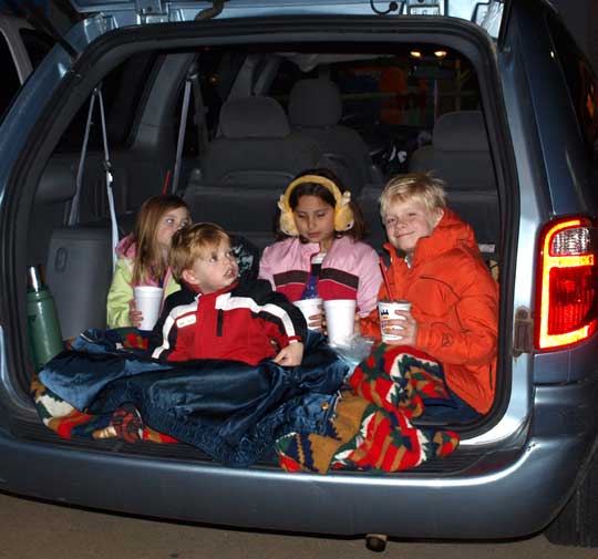 Children of the Fleeman and Powell families huddle in the back of their minivan as they wait for the parade to start.