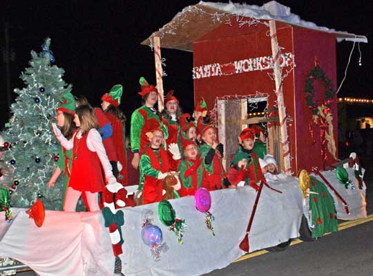 Passengers dressed as elves on a float in the Bryant Christmas Parade of Lights.