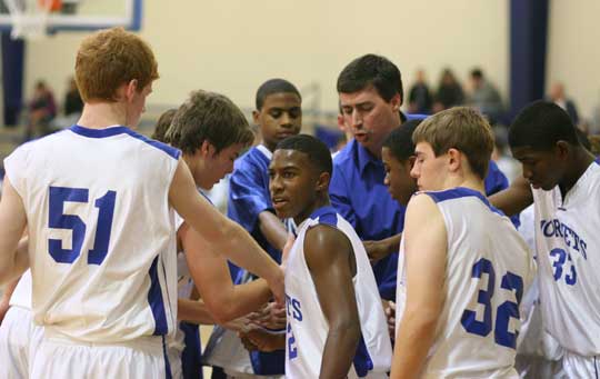 The Bryant Hornets freshman team huddles around head coach Steve Wilson during a timeout Thursday night. (Photo by Rick Nation)