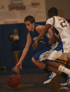 Bryant's Brandon Parish tries to drive past the hand check of North Little Rock's Reggie Bryles.