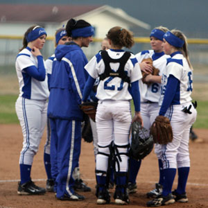 Bryant head coach Lisa Stanfield meets with her infield during a break in Monday's game.