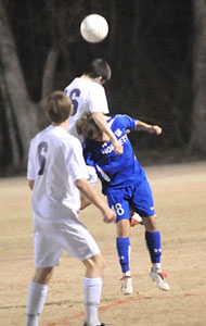 Peter Alverio and a Little Rock Catholic player both try to get their head on the ball.