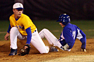 Bryant's Garrett Bock, 11, slides into second with a stolen base as Sheridan second baseman Zach Perkins reaches for the throw.