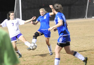 Bryant's Sarah Manning, 8, tries to get the ball ahead to teammate Erica Selig.